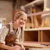 female-apprentice-working-as-carpenter-in-furniture-workshop